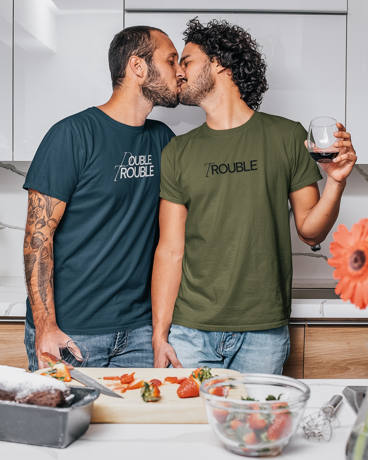 Gay Couple wearing matching Unapologaytic T-shirts Trouble and Double Trouble