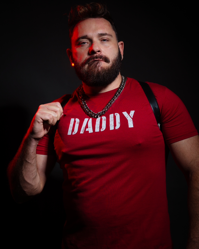 Handsome man wearing a red Daddy T-shirt from Unapologaytic 